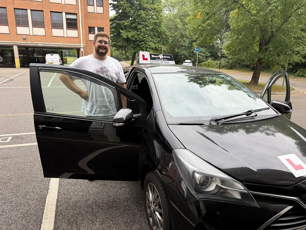 Red car parked in the center of an underground garage, surrounded by rows of silver and blue cars. Bright overhead lights illuminate the scene.