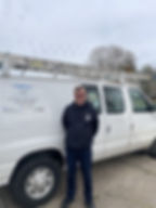 handyman with white van in the background