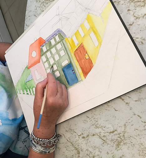 One of my students painting with her watercolor paints in class.