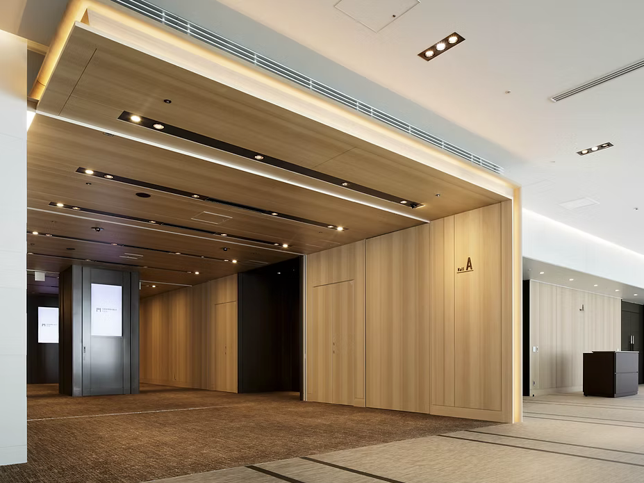 Modern commercial interior featuring woodgrain architectural finishes on walls and ceiling, showcasing 3M DI-NOC applications