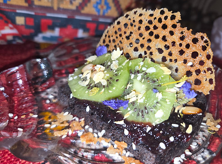 image of Course VII-A — Bring Me Home, Freshly baked black double-chocolate sourdough, served with seasonal fruit or house fruit syrup, gold accents, tahini, and Egyptian black honey. Finished with toasted nuts for texture and depth.