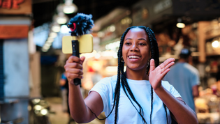 Young girl waving at her phone