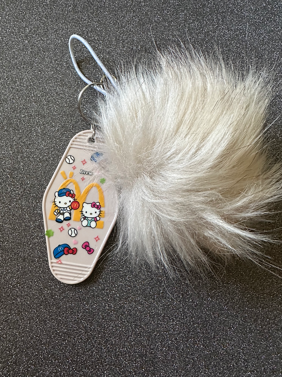 Two sided motel keychains with fake fur Pom poms.