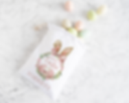 white drawstring bag with an easter themed wreath with easter eggs and bunny ears. pink theme