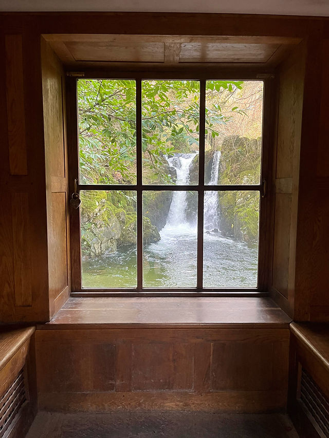 Looking through the window of Rydal Grot at the flowing waterfall outside