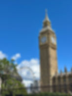 Elizabeth Tower and Big Ben on a sunny day in London with the London Eye in the background
