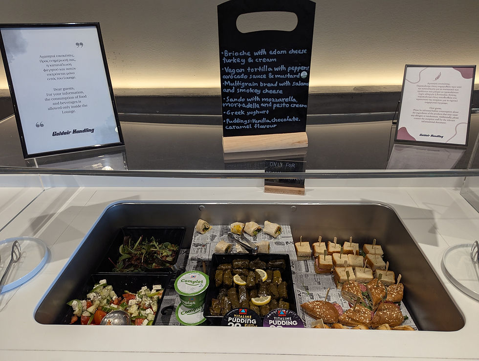 Assorted buffet food in trays, including salads, wraps, and pastries, Goldair Handling Lounge Corfu Airport
