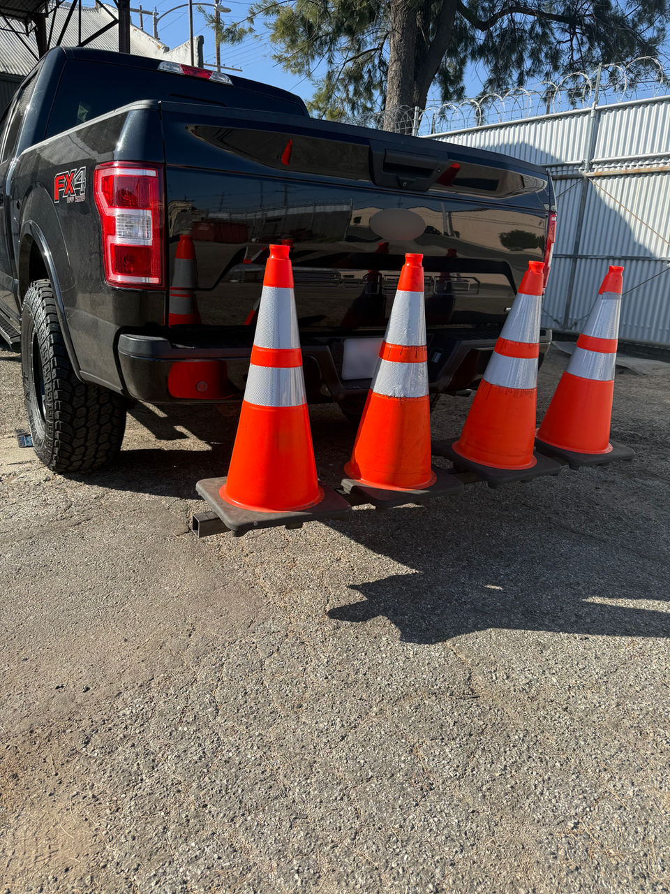 Hitch-mounted safety cone rack installed on a security truck for port and industrial safety operations