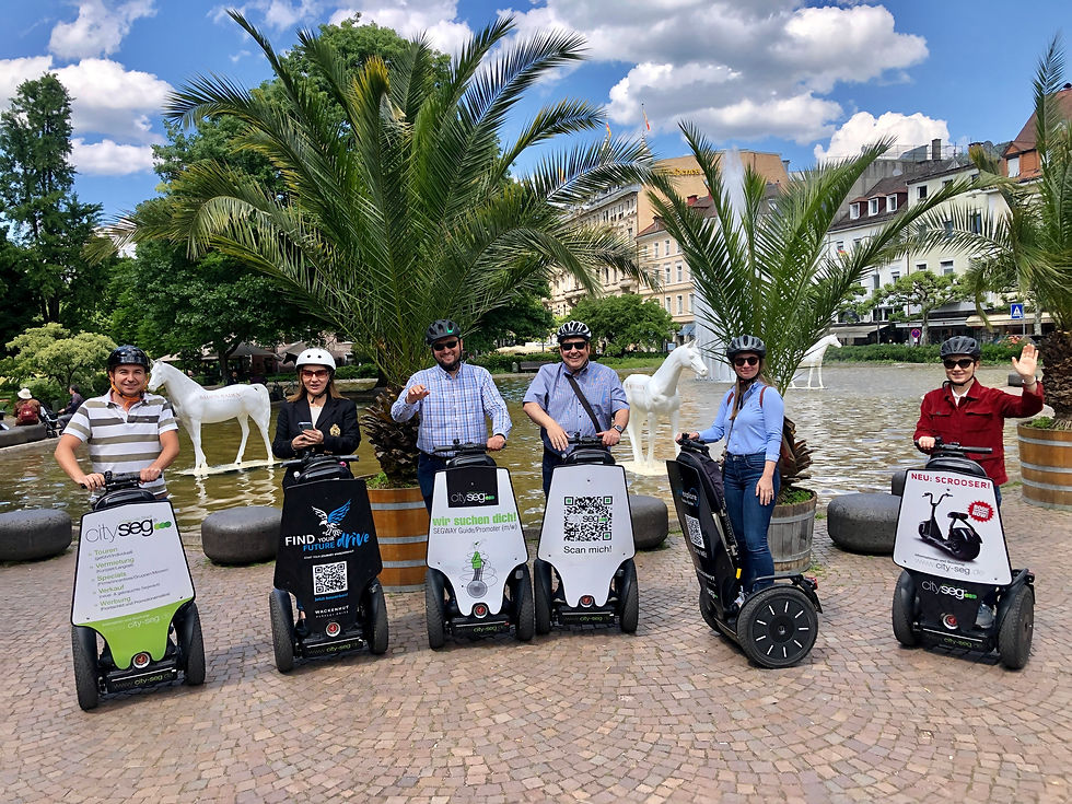 Wide angle view of a group riding Segways on a forest path