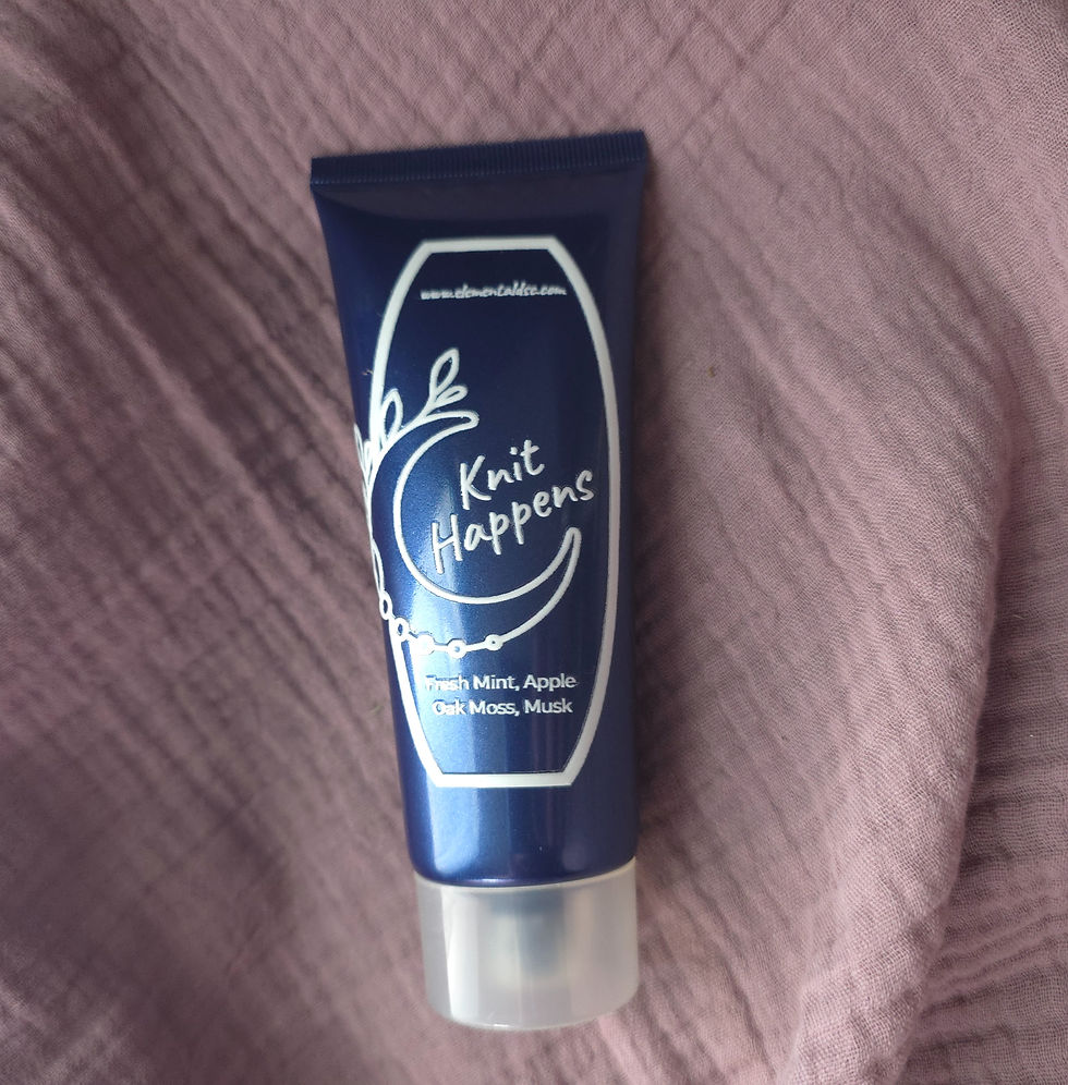 Thumbnail: Blue tube of Knit Happens cream with mint, apple scent on pink fabric