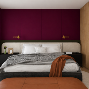 A suíte master da Casa Ânima traduz, em escala íntima, a essência que conduz todo o projeto: um espaço pensado para acolher, desacelerar e despertar sensações. A composição une materiais naturais, tons profundos e iluminação suave para criar uma atmosfera envolvente, onde conforto e personalidade coexistem com equilíbrio.

A madeira aquece o ambiente e reforça a conexão com a natureza, enquanto o painel em tom vinho intenso imprime identidade e profundidade ao espaço, quase como uma extensão emocional da arquitetura. A luz natural filtrada pelas cortinas valoriza a sensação de calma e bem-estar, permitindo que o ambiente se transforme ao longo do dia de maneira sutil e acolhedora.

Mais do que um dormitório, a suíte master da Casa Ânima foi concebida como um refúgio: um espaço resguardado, silencioso e sensorial, onde cada escolha, das texturas às cores, da iluminação à composição, contribui para uma experiência de acolhimento genuíno. Uma atmosfera com alma, criada para desacelerar o olhar e trazer presença ao cotidiano.