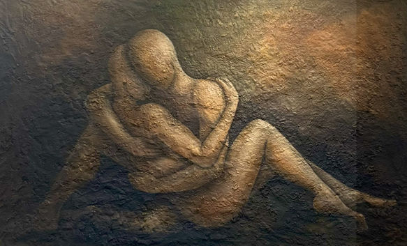 A couple, sitting in a tender embrace.