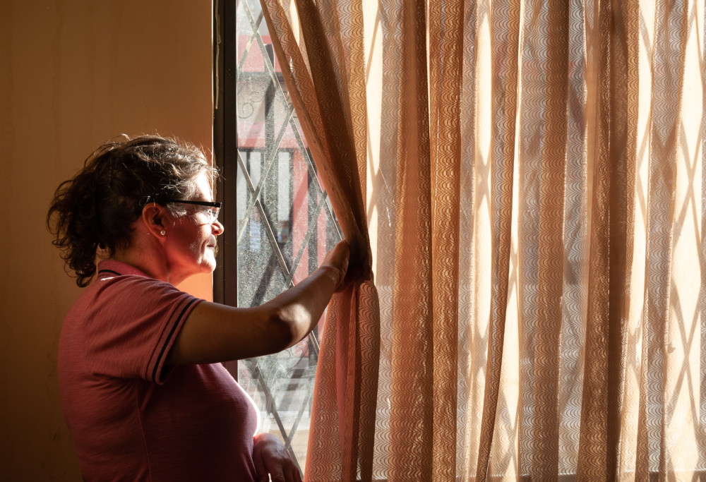 senior woman looking out window