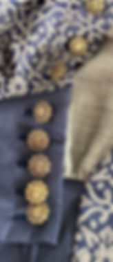 Close up of garment with gold buttons