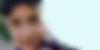 Close-up of teenage boy looking at the camera with a slight smile