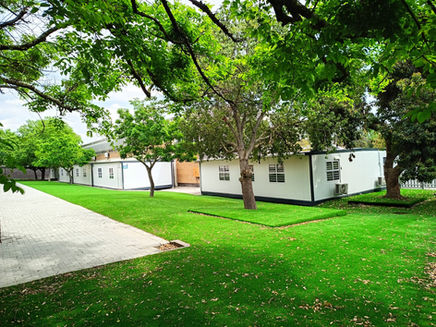 Modular school classroom buildings beside landscaped grounds
