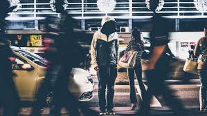 hooded man in busy street