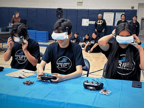Three students wearing FPV goggles prepare to pilot mini racing drones during a school drone competition, part of the Drone Legends FPV Initiator curriculum teaching real-world drone and career skills.