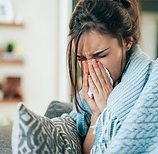 Sick woman blowing her nose