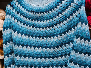 A knitted shawl in shades of blue