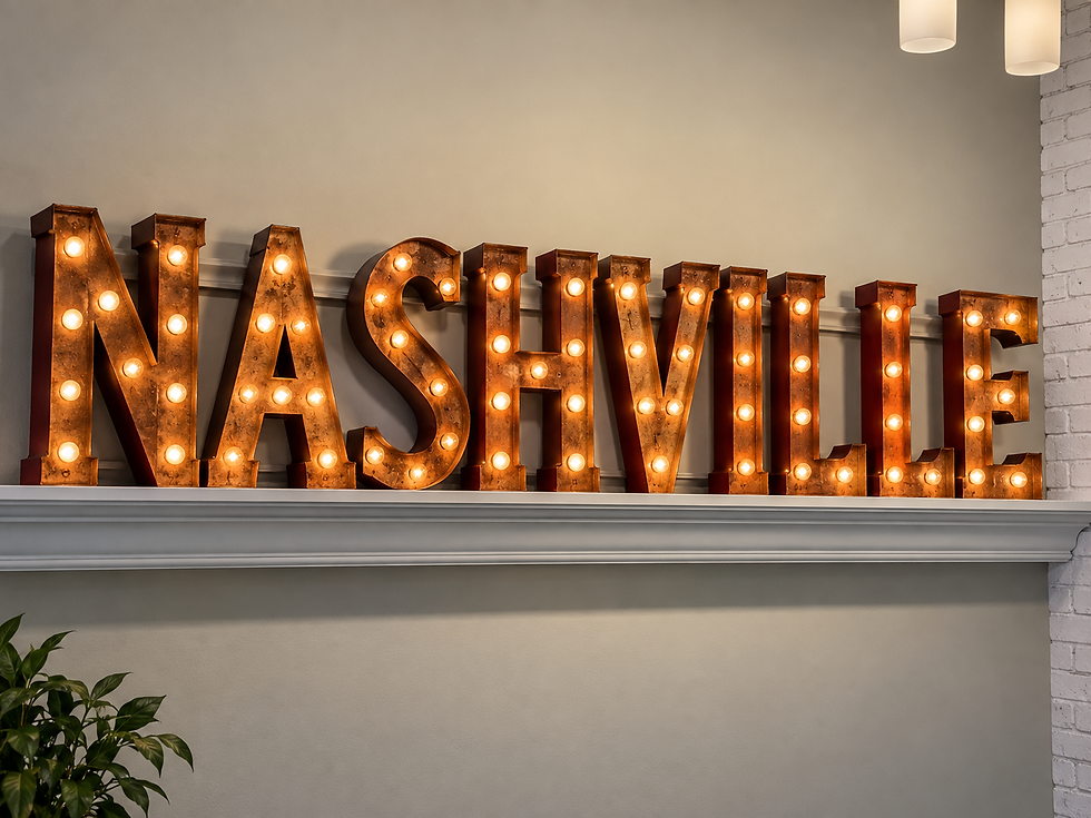 Large illuminated marquee letters spelling “NASHVILLE” sit on a white mantel against a neutral wall, glowing with warm vintage-style light bulbs.