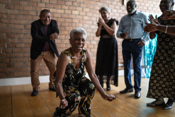 An older black woman dancing in a dance class
