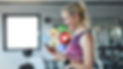 Smiling woman checking social media on phone after workout
