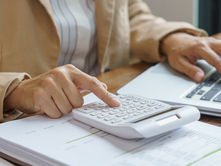 Photo of a woman calculating how much a magnet therapy session costs.