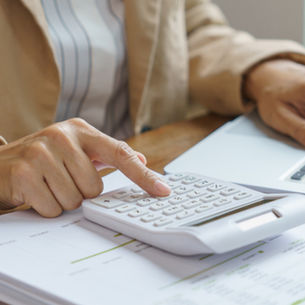 Photo of a woman calculating how much a magnet therapy session costs.