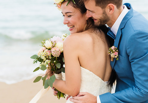 cheerful-newlyweds-beach-wedding-ceremno