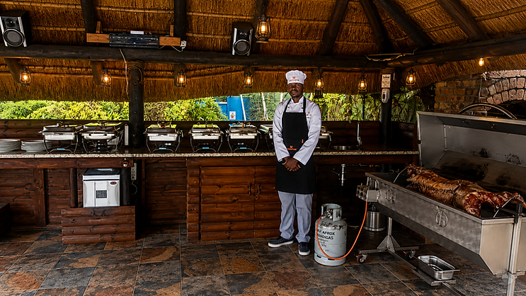 ThymeKitchen chef beside a lamb spit braai setup for an event in Cape Town