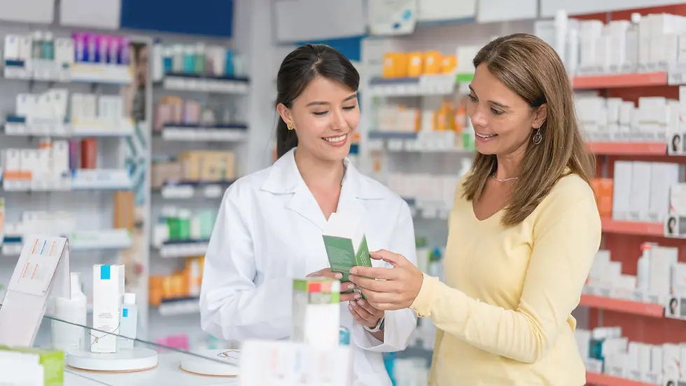 Pharmacist in Costa Rica helping a woman review medication at a local farmacia. Pharmacies are common across Costa Rica, offering affordable prescriptions and over-the-counter medicines to expats and locals