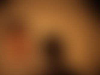 Waymon Hudson, queer writer and musical creator, spotlighted against a warm-toned background with dramatic shadow — representing visibility, storytelling, and creative duality.