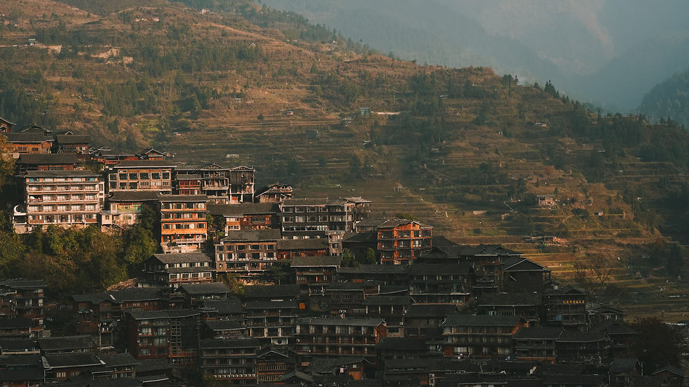 Terraced fields and traditional wooden buildings in Xijiang Qianhu Miao Village, Guizhou, China