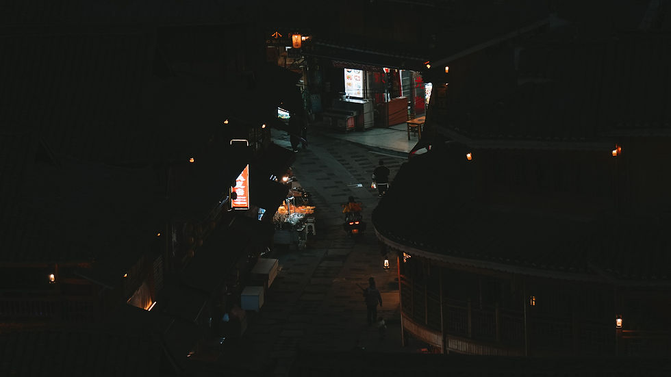 Locals on narrow street at night in Xijiang Qianhu Miao Village, Guizhou, China