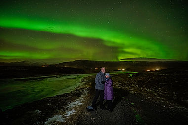 Brian & Monica under the Northern Lights outside of Reykjavik, Iceland in January 2023