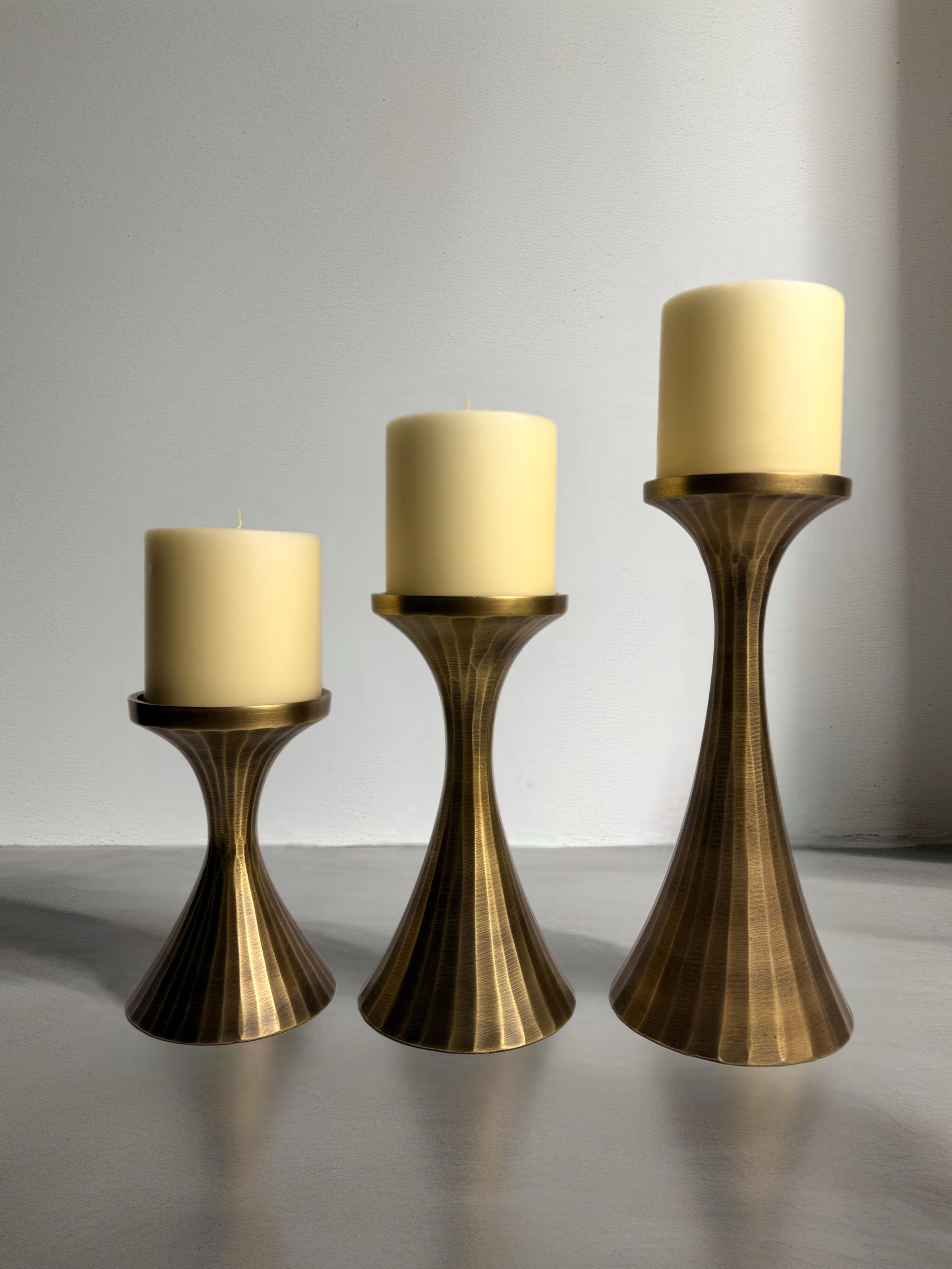 three piece Torre & Tagus aluminum candle holder side by side view