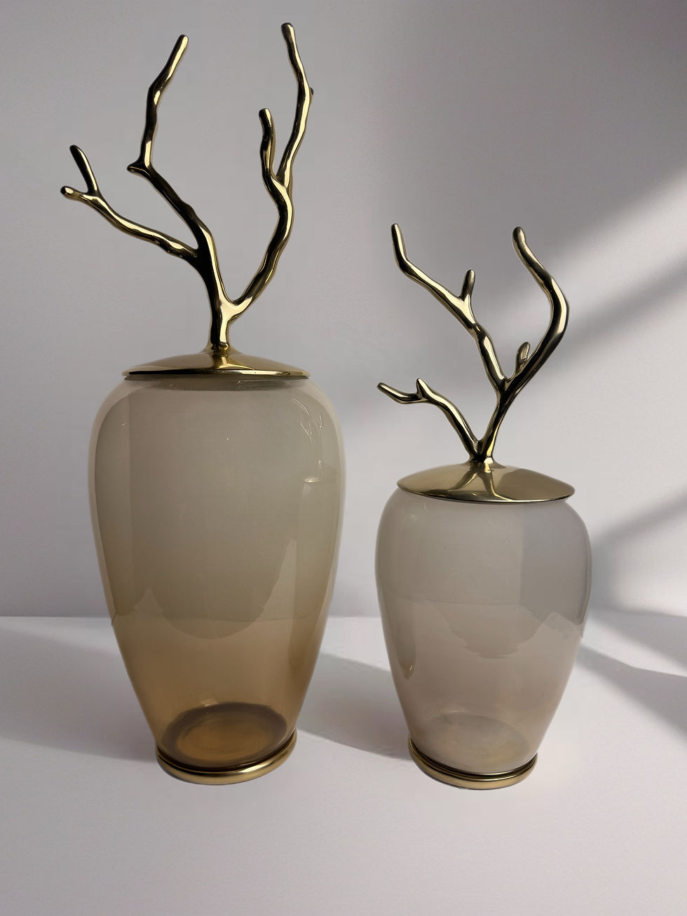two amber smoke glass jars in different sizes, front view