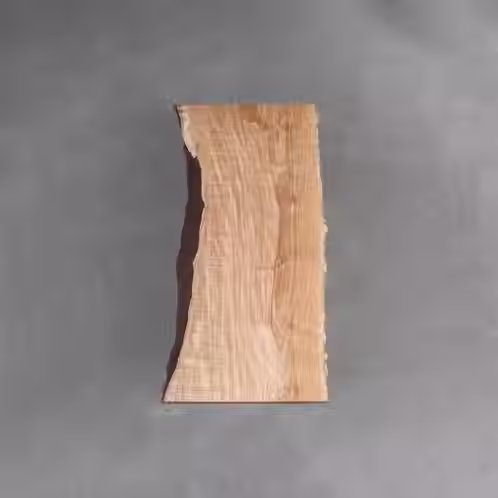 Japanese Ash, known as Tamo, pairs a pale, light-brown tone with some of the most distinctive figuring in the world, from sweeping swirls to its famed peanut-shell pattern. It is elastic, workable, and polishes beautifully.
You want calm without plainness. You are drawn to bright, airy spaces where one quietly extraordinary surface carries the whole room.