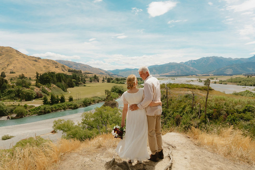 A couple looking at each other while standing at the Hanmer Springs lookout in New Zealand