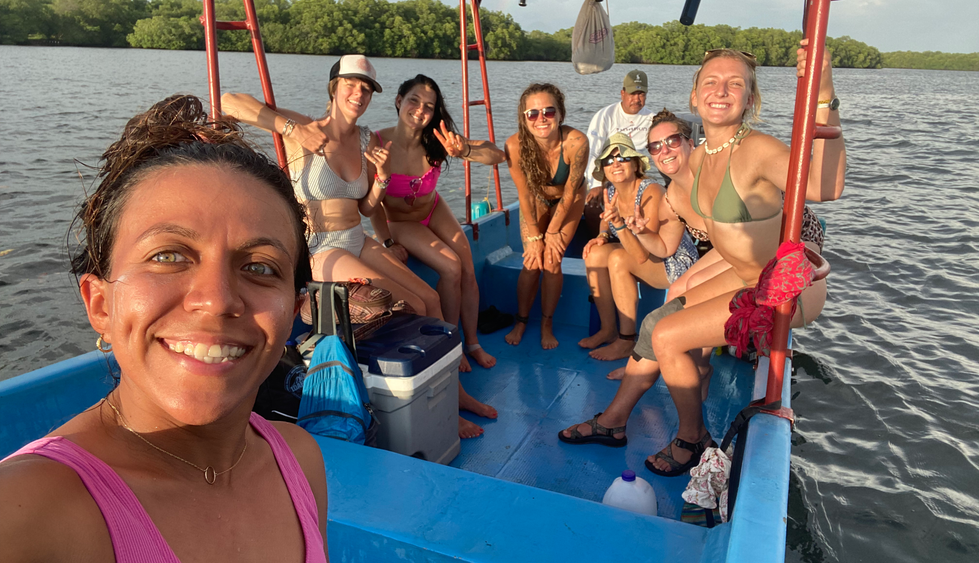group of people on a boat smiling at the camera