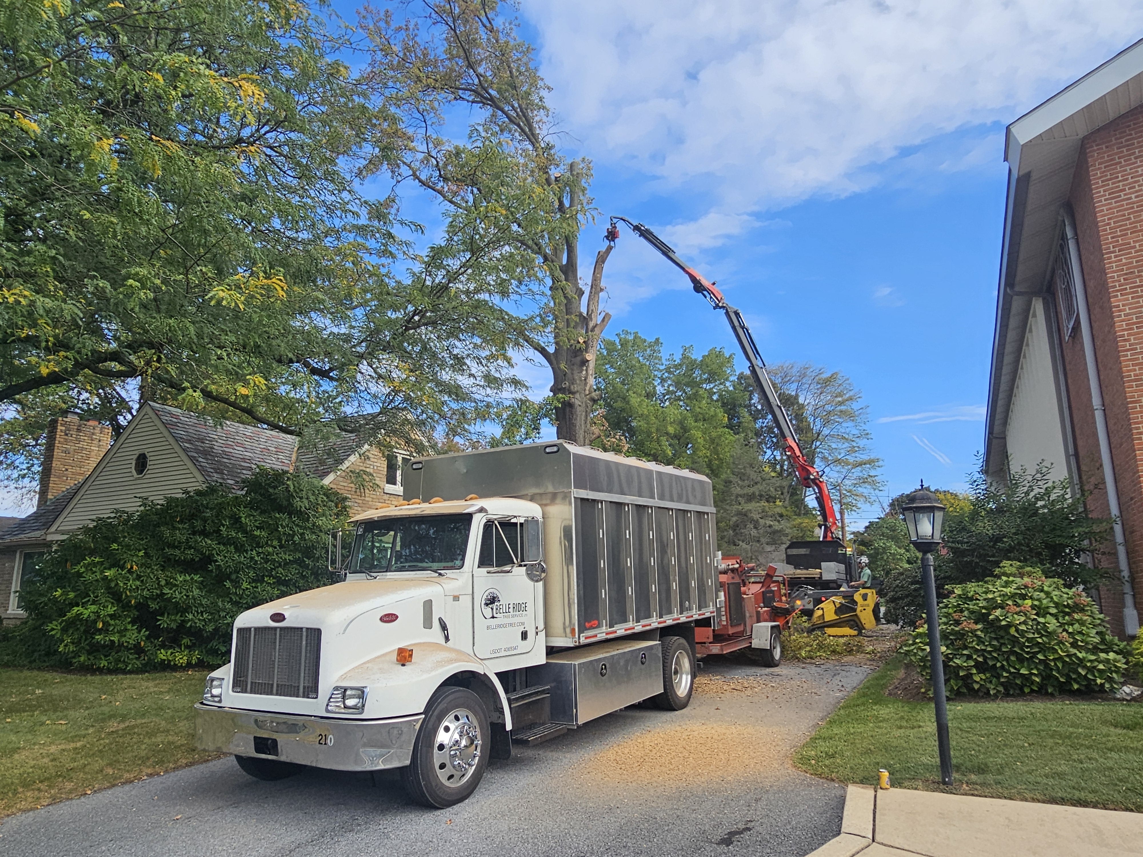 Specialized tree removal equipment in Lancaster County PA including cranes and professional crews handling complex removals near structures