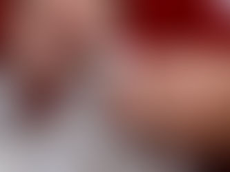 Close-up of elderly hands carefully embroidering white linen with delicate floral patterns, symbolising the precision and tradition of Madeira embroidery.