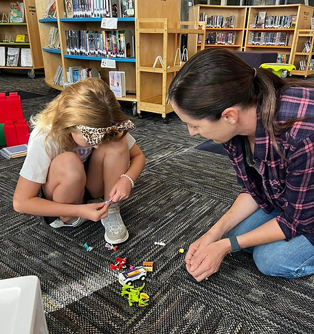 A parent helping a child at Lego Club