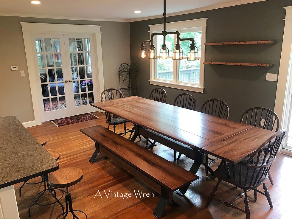 Eye-level view of a contemporary glass and metal dining table set against a minimalist backdrop