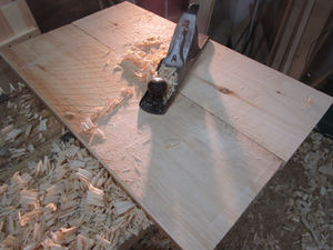 An antique hand plane on a soild wood table top