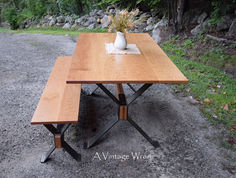 Massachusetts modern industrial trestle dining table and bench set, features a dark metal X style legs with a warm wood top.