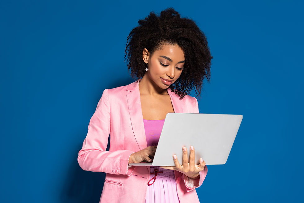 VistaCreate-342972102-stock-photo-elegant-african-american-businesswoman-using-laptop-blue