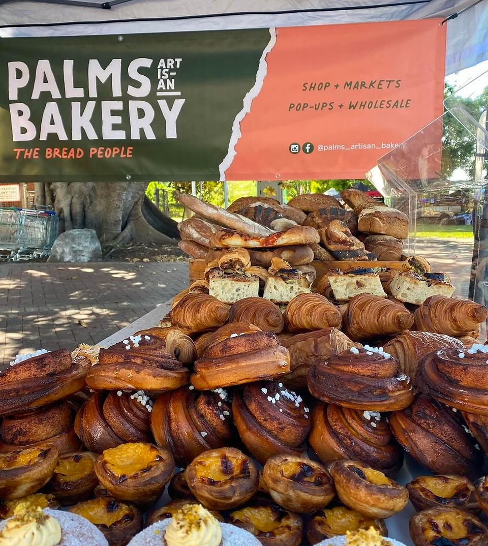 Palms Bakery stall with croissants and pastries at Pacific Palms.