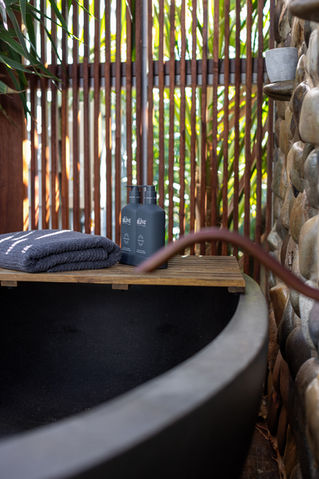 Outdoor black stone bathtub, with boutique products for the ultimate relaxation at Boomerang Beach Coast Holiday Home